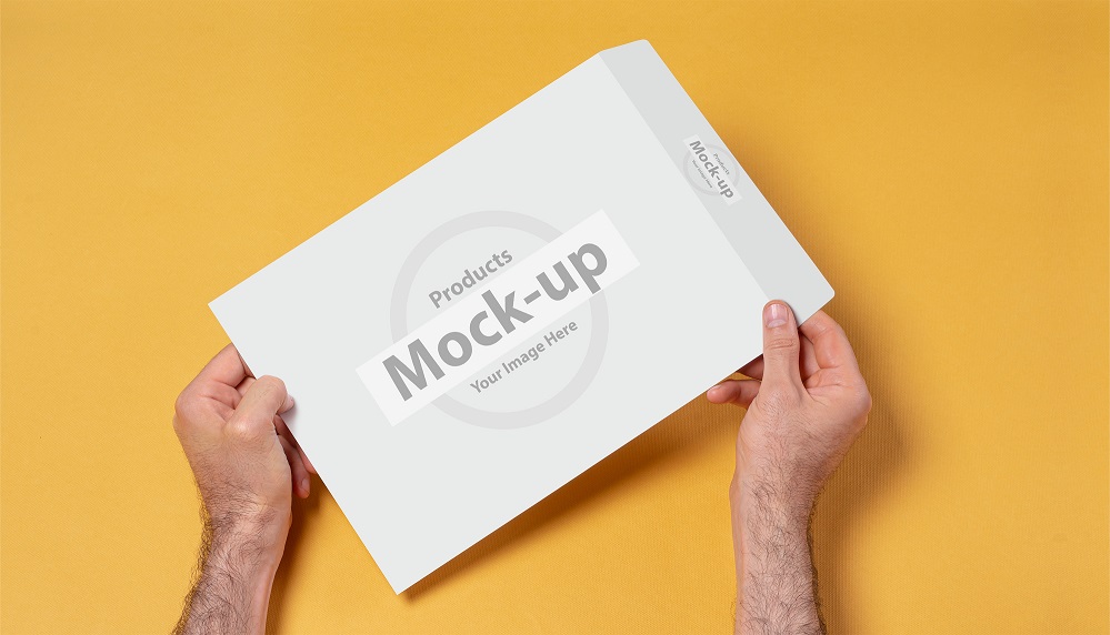 Hand Holding Paper Envelope Mockup PSD Free Download